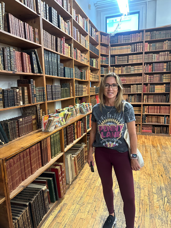 Janelle browsing a used bookstore